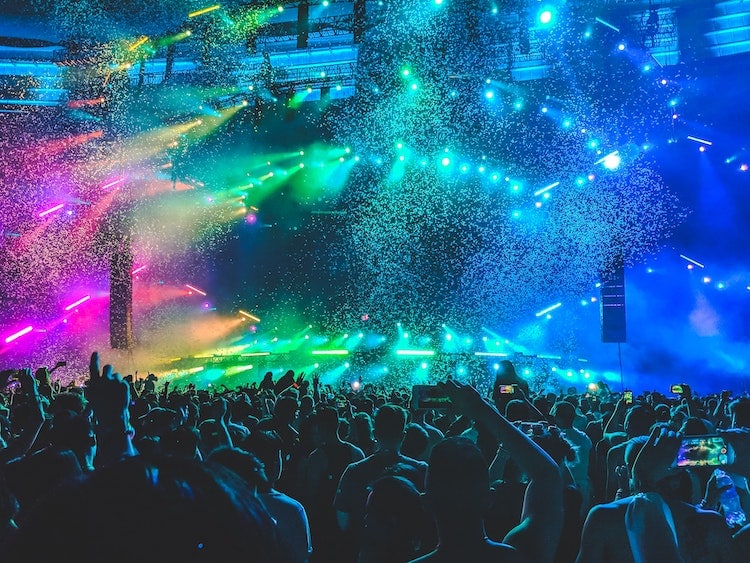 people dancing at a concert with confetti